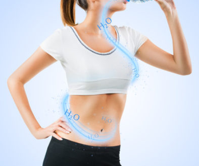 Fit young woman drinking water