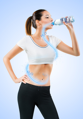 Fit young woman drinking water